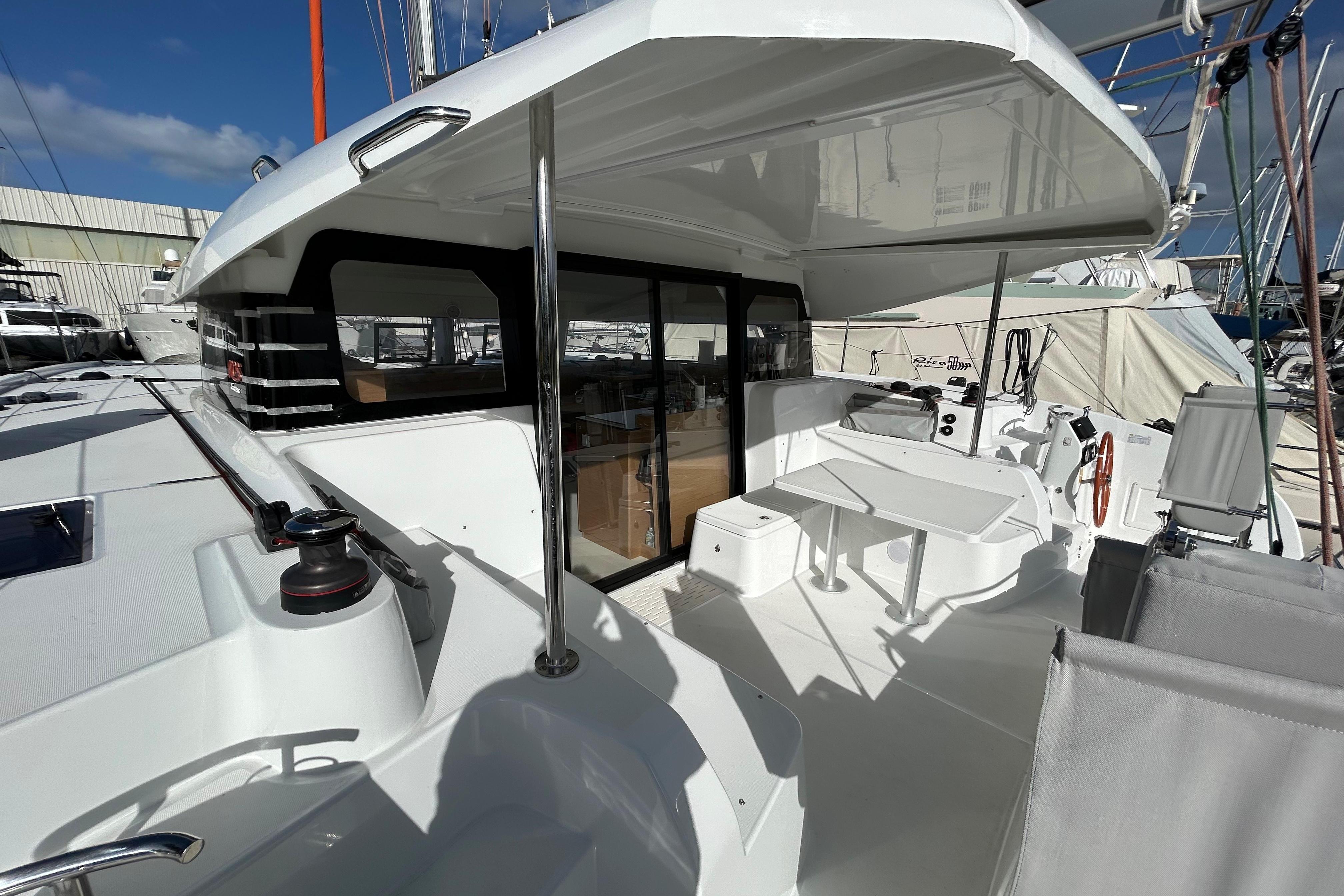 Aft cockpit with helm, hardtop, and dining area